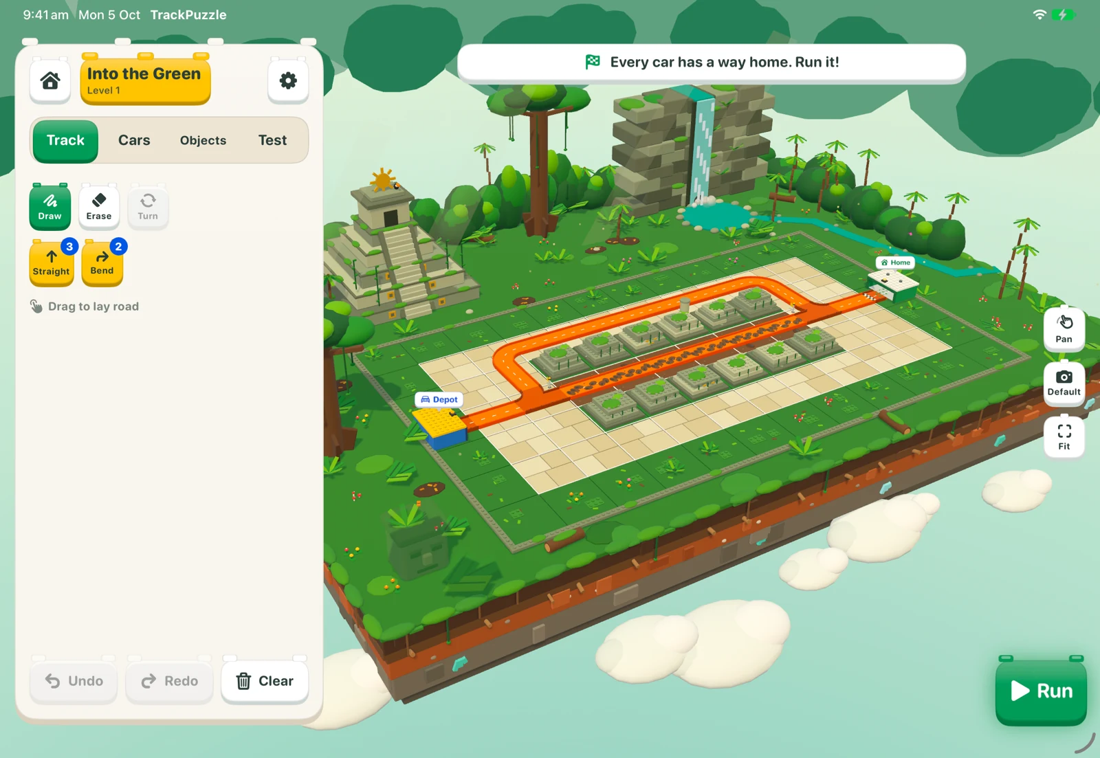 Track Puzzle’s Jungle route builder: a winding track on a lush floating island, with a waterfall, temple, and track-piece palette